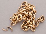 a pile of gold chains on a table