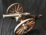 an image of a cannon on wheels on a black background
