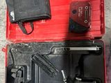 a red tool case with tools in it on the floor