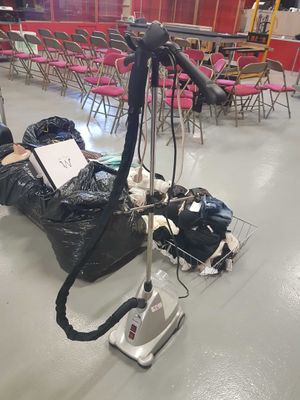 a bag of trash sitting on the floor next to a vacuum