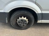 a white van that has a flat tire on it