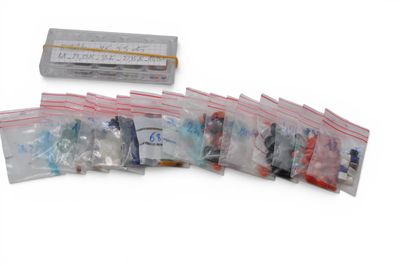 a lot of small bags of toothbrushes and toothpaste