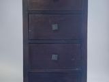 an image of a tall chest of drawers against a white background