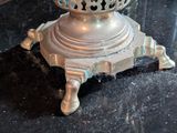 a silver vase sitting on top of a black table