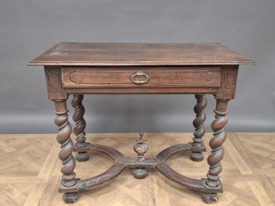 an old wooden table with a drawer on top of it on a hard wood floor