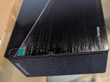 a black box with a black cover sitting on top of a table