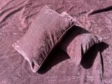two pillows that are laying on a bed together