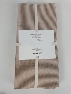 the folded towel is brown and white with a tag on it