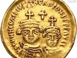 a gold coin with two heads and a cross on it