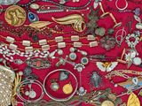 a red display case filled with lots of assorted jewelry