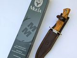a knife with a wooden handle next to a box of muela