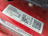 a close up of a red motorcycle with a sticker on it