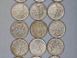a collection of silver coins from around the world
