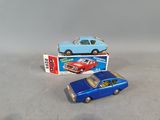 two toy cars sitting next to each other on a table
