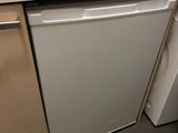 a white dishwasher sitting in the corner of a kitchen