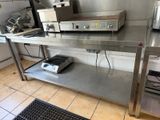 a large stainless steel table with a machine on it