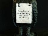 a statue of a gorilla with a sign on it ' s back