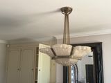 a chandelier hanging from the ceiling in a kitchen