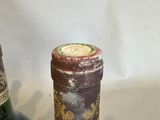 two bottles of wine sitting next to each other on a table