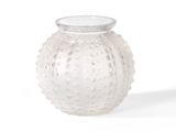 a white glass vase with a white lid on a white surface