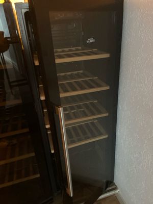a wine cooler that is next to a wall