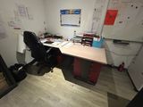a desk with a chair and a mirror in the corner