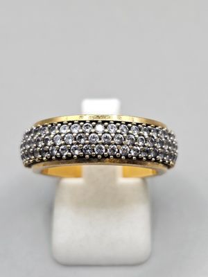 a gold and silver ring with black and white diamonds