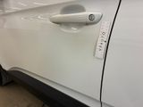 a sticker on the door handle of a white car