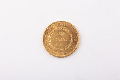 a close up of a gold coin on a white surface