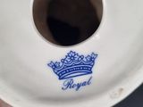 someone is holding a plate with a royal crown on it