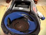 a blue and black blower sitting on the floor