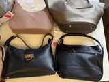 several purses are sitting on a table in a room