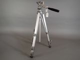 a silver tripod with a black handle on a gray background