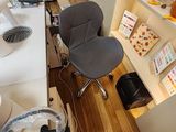 a desk with a computer and a chair in the room