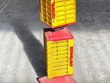 yellow and red boxes stacked on top of each other in a garage