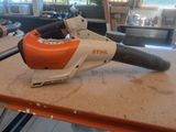 an orange and white leaf blower sitting on top of a table