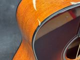 a close up of a guitar on a stand with a black background