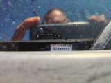 someone taking a picture of themselves in the rear view mirror of a car