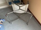 an image of a laundry basket on a stand in the corner of a room
