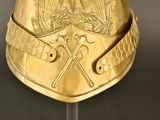 a gold helmet with a bird on it on a stand