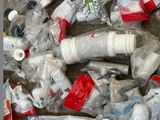 a pile of plastic bottles and other items on the ground