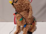 a brown teddy bear with a christmas hat on