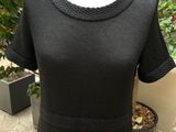 the dress is black and has a short neckline and short sleeves