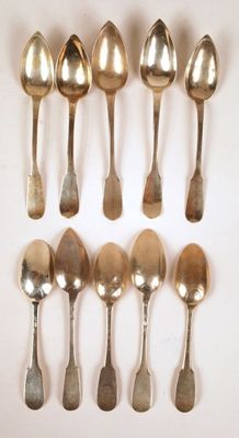 six silver spoons are arranged in a row on a white surface