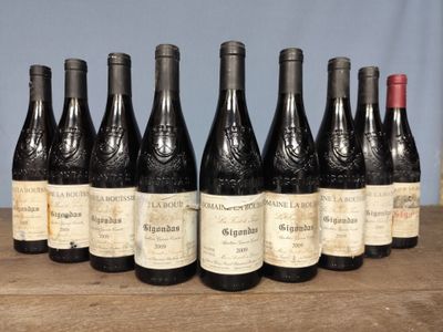 several bottles of wine are lined up on a wooden table