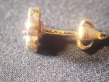 a pair of earrings that are sitting on a table