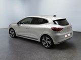 the rear end of a silver car in a white room