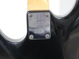 a close up of a guitar with a wooden neck