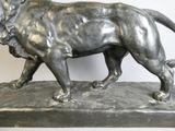 a statue of a lion that is standing on a rock