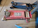 some tools are laying out on the floor next to a red fire hydrant